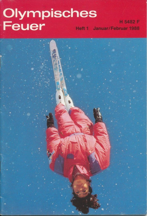 Buchumschlag mit einem Skifahrer in der Luft in einem roten Ski-Anzug, beschriftet mit "Olympische Spiele Feuer - Heft 1 - Januar/Februar 1988."