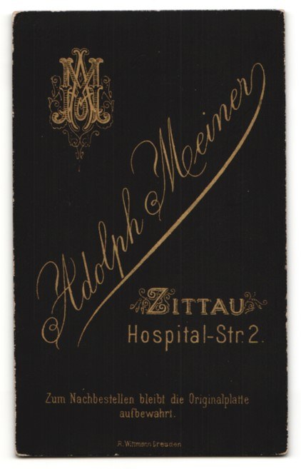 Schwarzes Buch mit goldener Schrift, das "Adolph Meiner - Zittauer Hospital-Str 2" auf einem weißen Hintergrund liest.